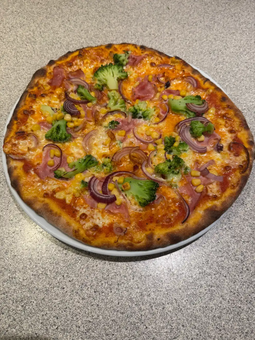 Knusprige Gemüsepizza mit frischen Zwiebeln, zartem Brokkoli und süssem Mais.